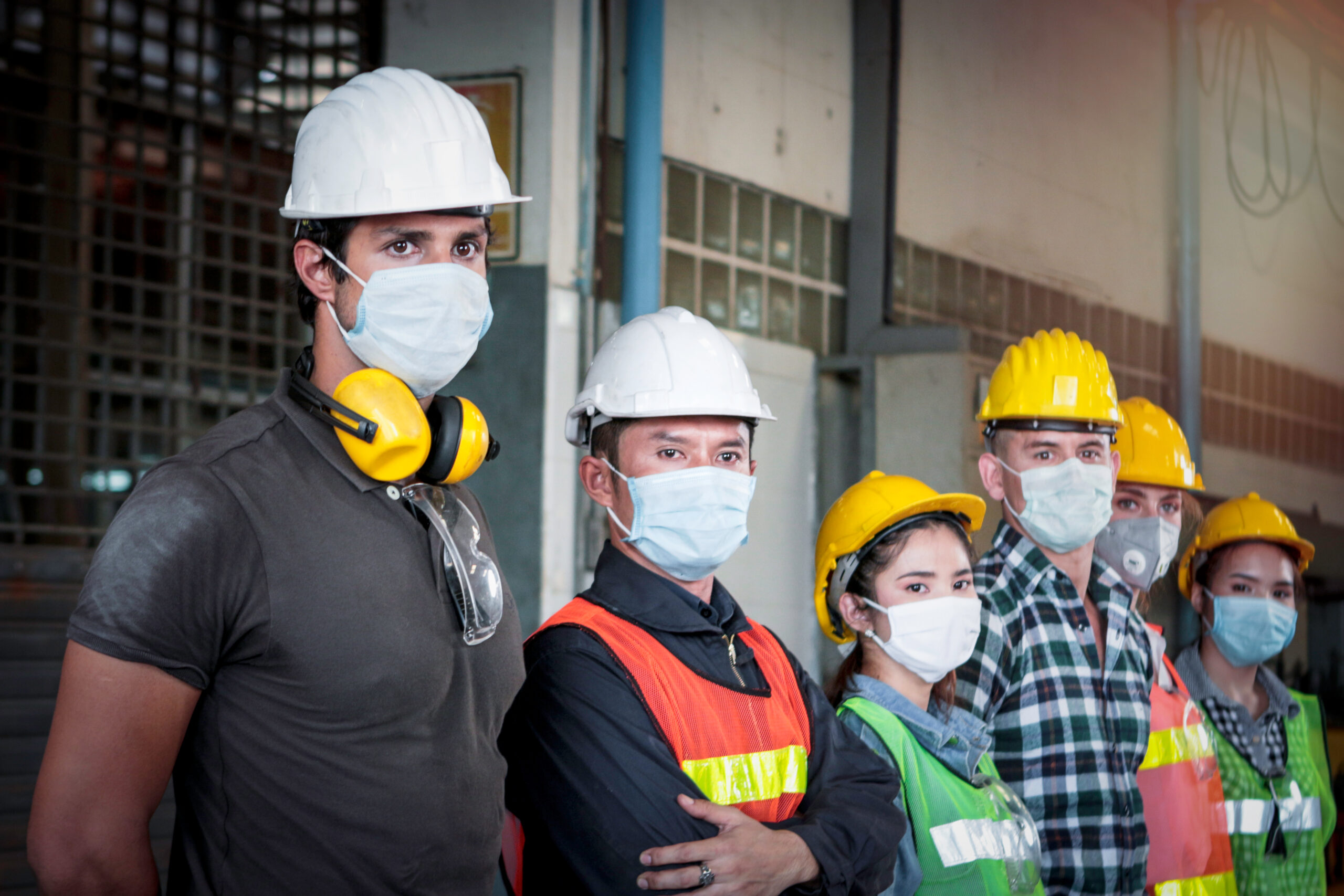 Warehouse employees standing and wearing masks