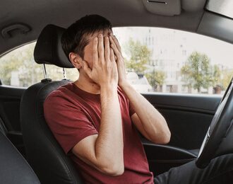upset person sitting in car