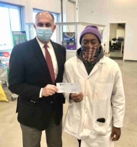 George Jebaily handling a check to Sav a Lot Owner for Thanksgiving Meals