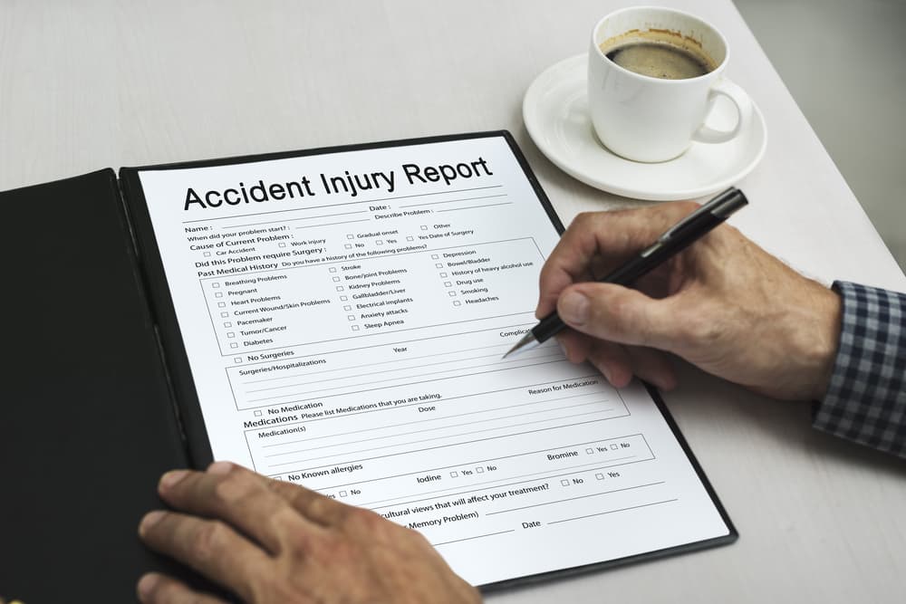 person filling out workers accident report
