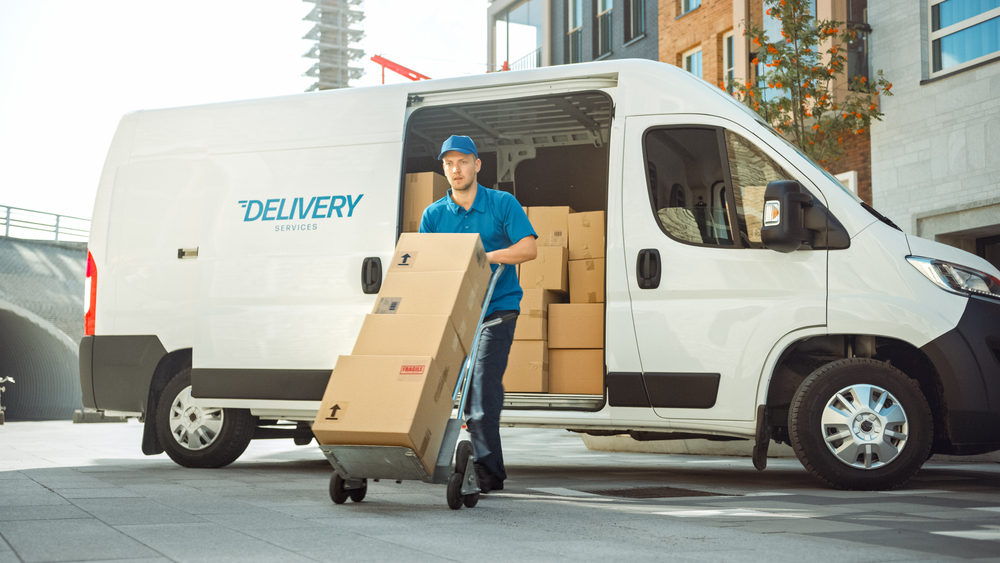 delivery truck driver pushing package