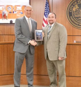 George Jebaily receiving award plaque from Don Strickland