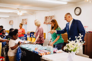 Jebaily Law Firm staff handing out supplies to school children