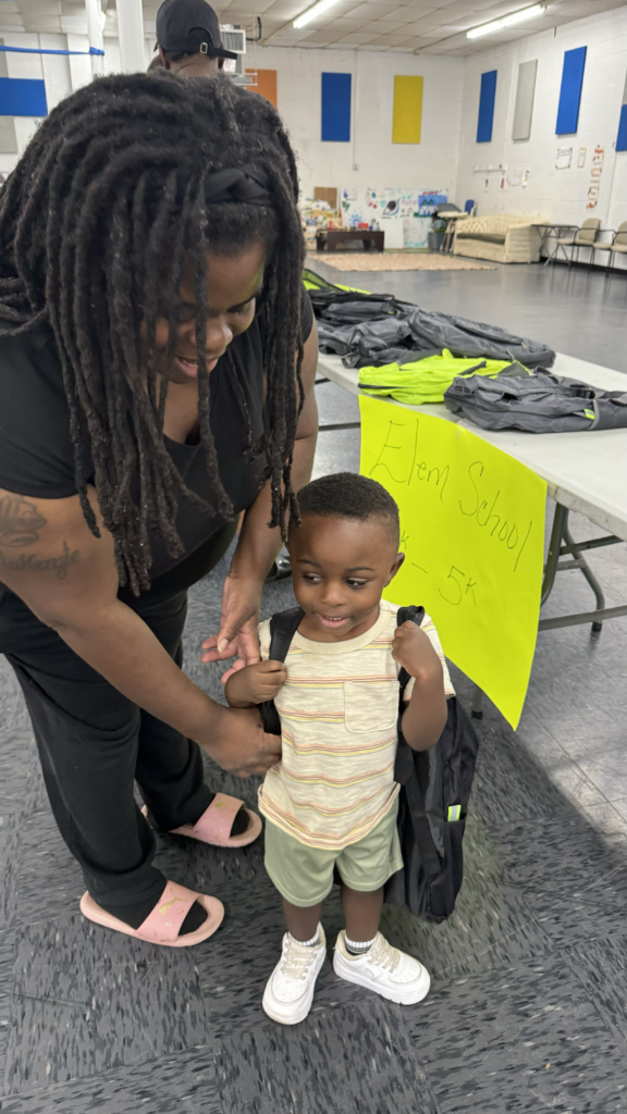 small boy wearing a new backpack