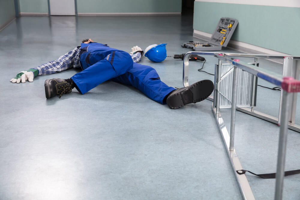 Unconscious Handyman Fallen From Ladder With Equipments Lying On Floor Worker Falling Off Ladder And Injuring Leg