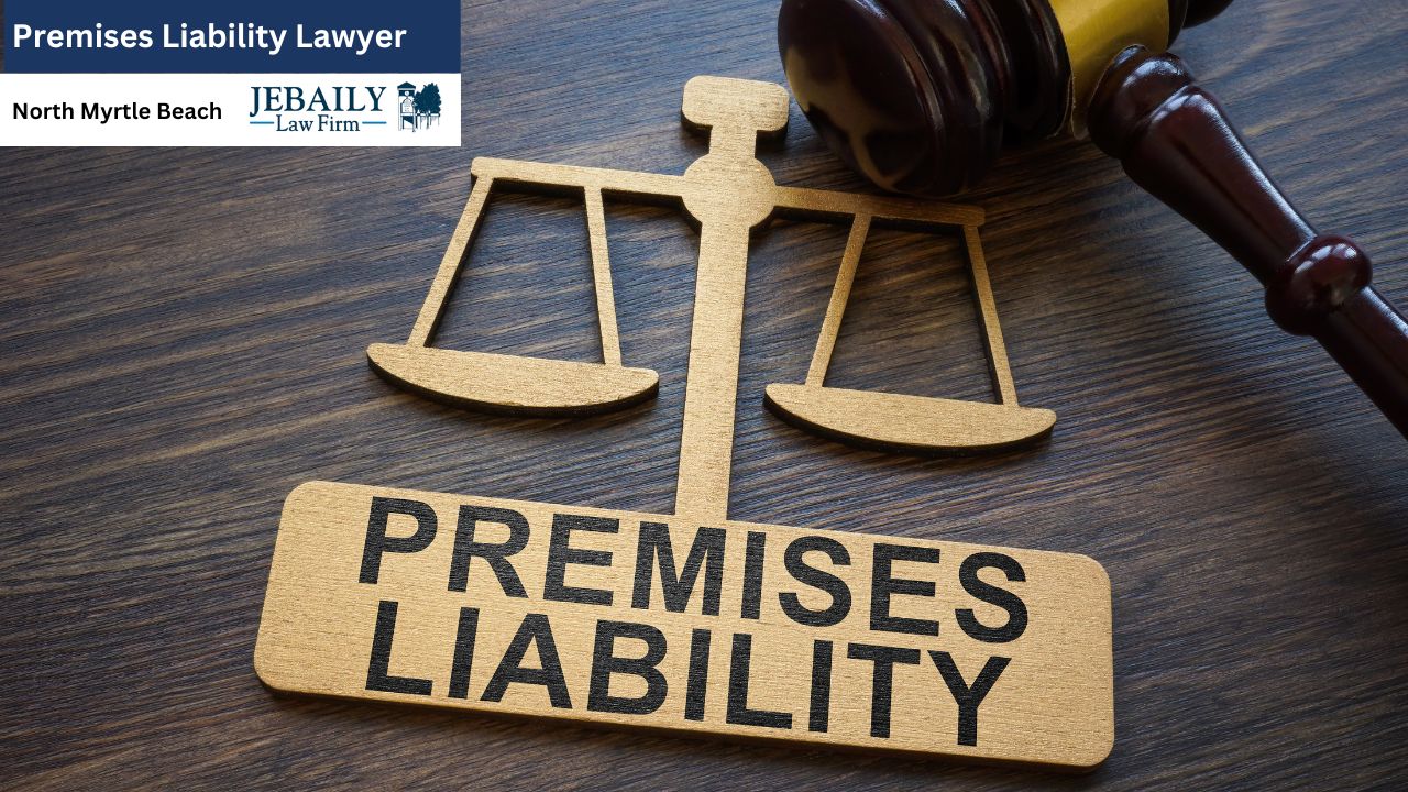 The image features a wooden sign that prominently displays the words "Premises Liability Lawyer North Myrtle Beach" along with the name "JEBAILY - Law Firm." Accompanying the sign on a table are a scale and a gavel, symbols often associated with justice and legal matters. The scene is set against a floor backdrop.