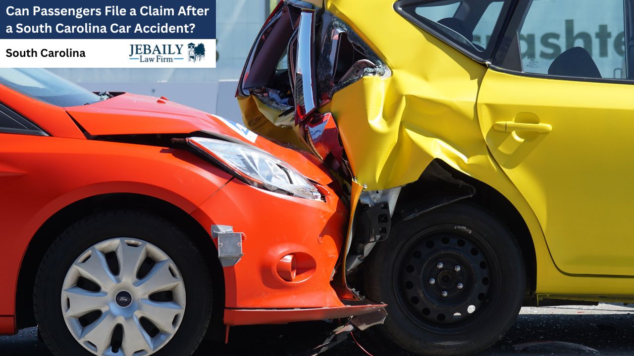 Two severely damaged cars, one red and one yellow, are locked together after a collision, highlighting the aftermath of a car accident.