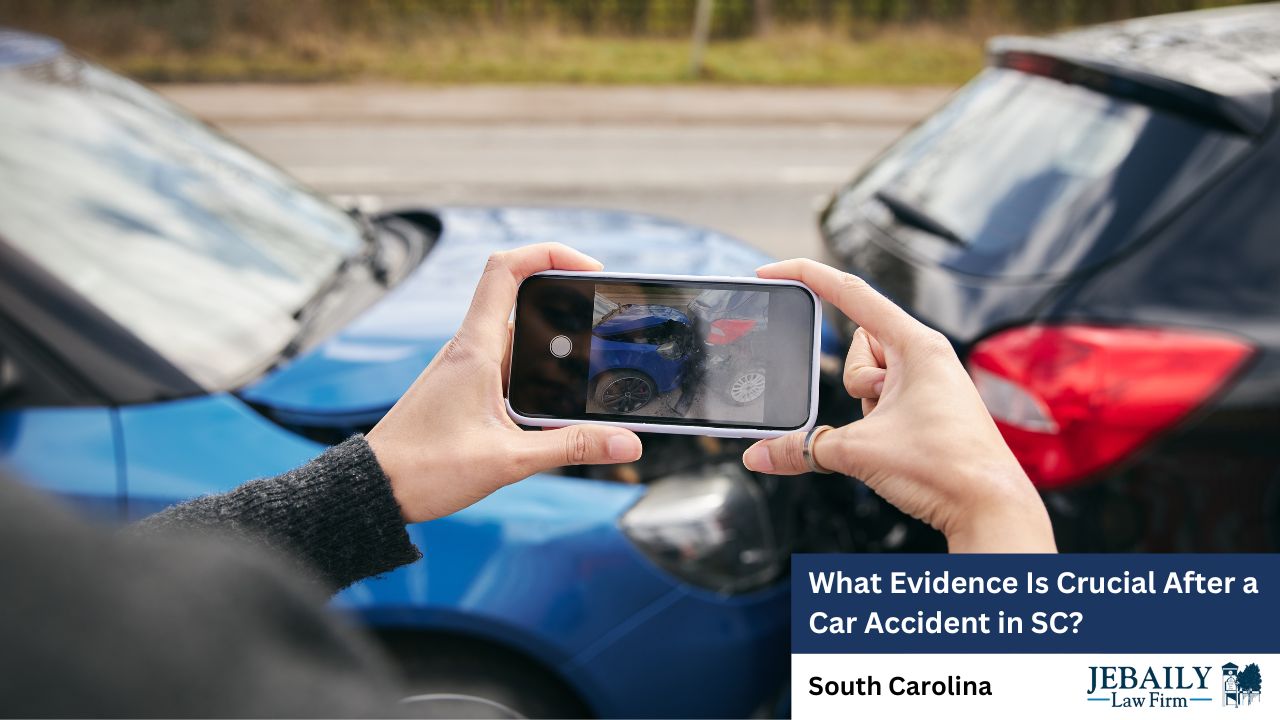 A person is holding a mobile phone, likely capturing evidence related to a car accident. The scene includes elements such as vehicles, mirrors, and an outdoor setting. The image suggests a focus on important steps that should be taken after a car accident in South Carolina, possibly for legal purposes.
