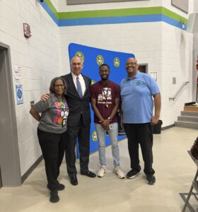 George Jebaily posing with staff from Delmae Heights Elementary at Dads Breakfast