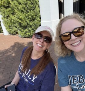 Kathryn Funderburk and Rangeley Bailey sit at the Jebaily Law Firm hydration station