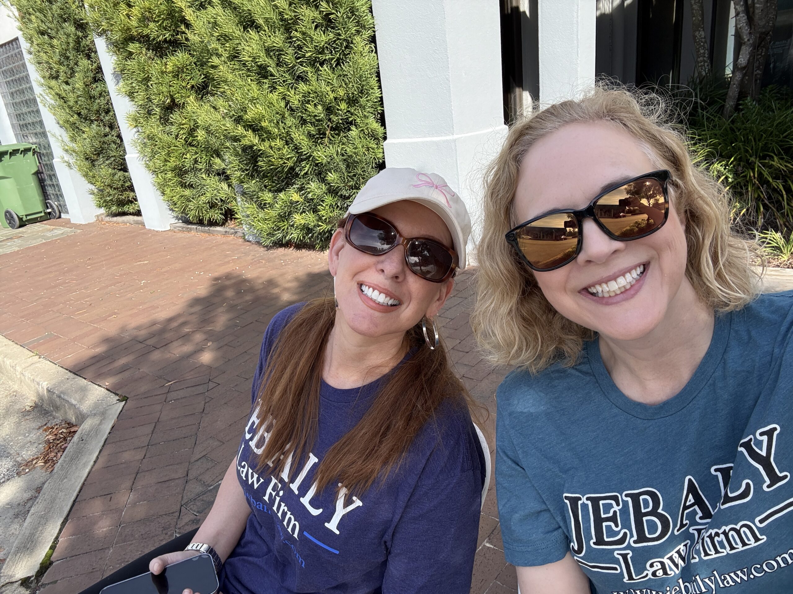 Kathryn Funderburk and Rangeley Bailey sit at the Jebaily Law Firm hydration station