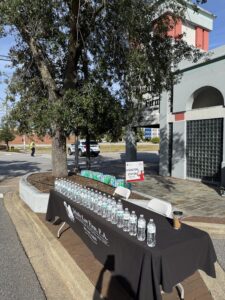 long folding table with water bottles outside of Jebaily Law Firm