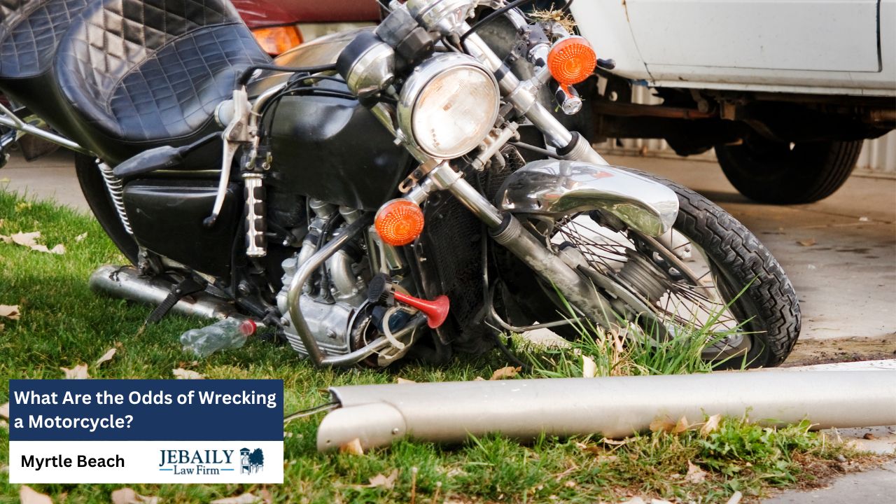 The image depicts a wrecked motorcycle lying on a patch of grass, reflecting a somber aftermath.